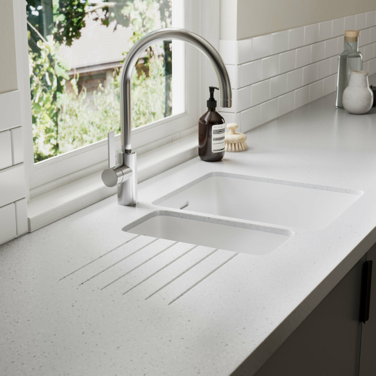 White Durasein kitchen worktop with an integrated sink and drainer grooves
