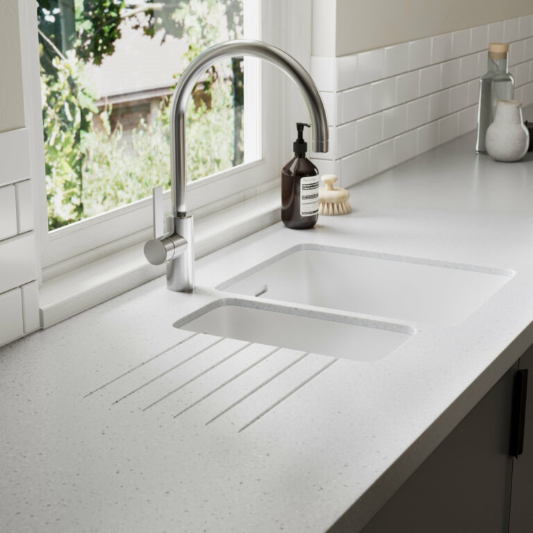 White kitchen worktop with an integrated sink and drainer grooves