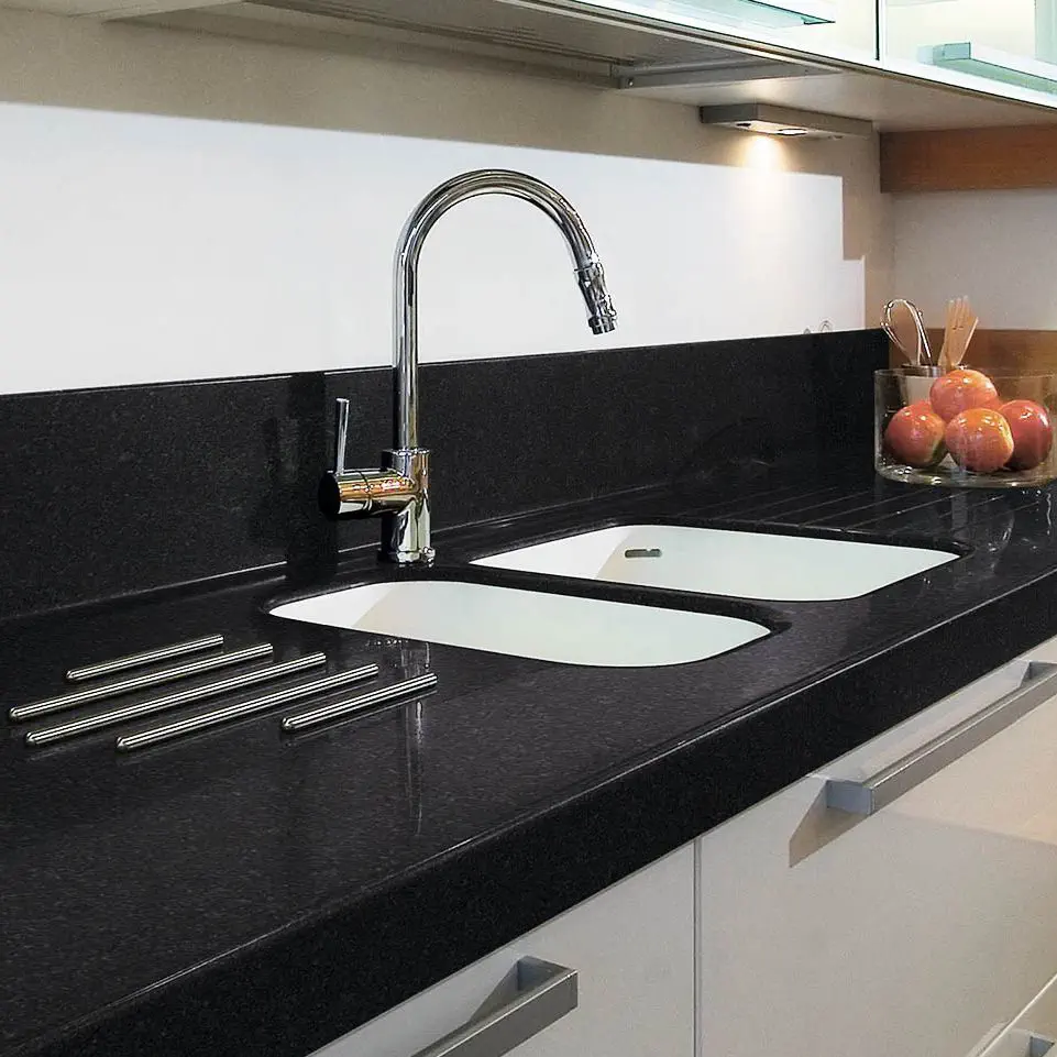 Contemporary kitchen design with white cabinets and a black granite worktop.