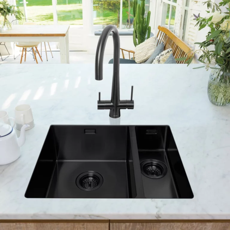 White kitchen worktop with a black steel Caple undermount kitchen sink