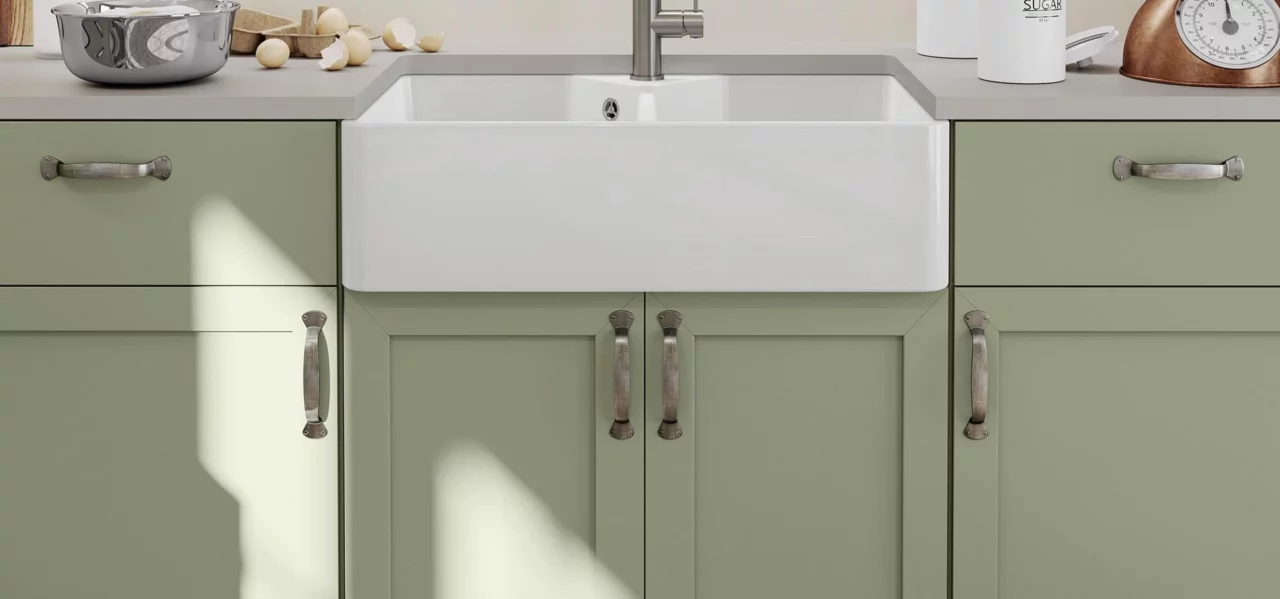 Green kitchen with grey worktops and a white Blanco Villae undermount sink